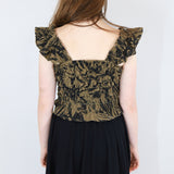 Model wearing a black and brown shirred flutter sleeve cotton blouse featuring a fox print paired with a matching black skirt.