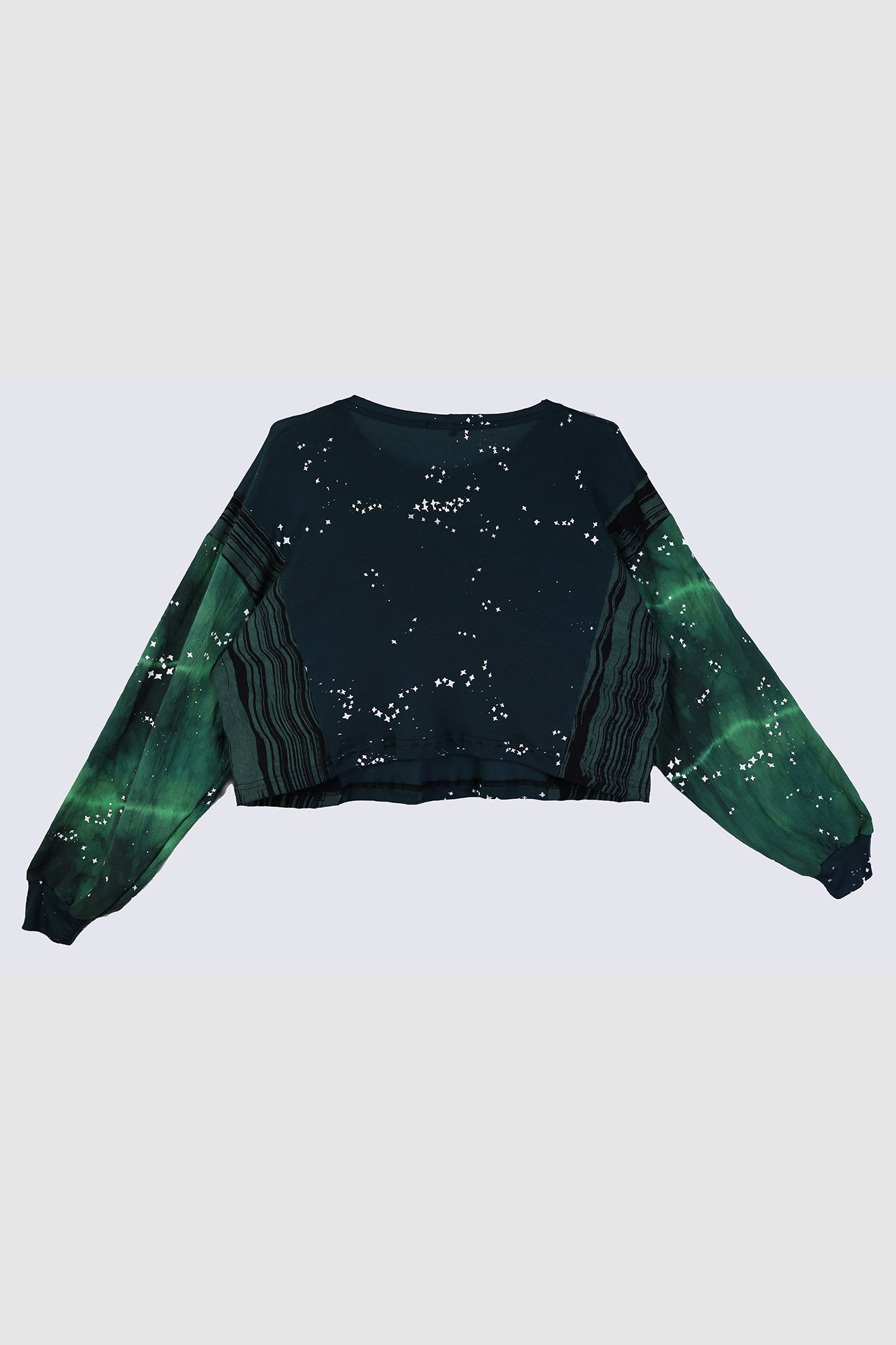 Black and green gradient crop top with star pattern on a white background