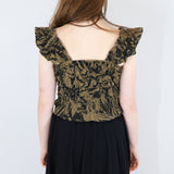 Model wearing a black and brown shirred flutter sleeve cotton blouse featuring a fox print paired with a matching black skirt.