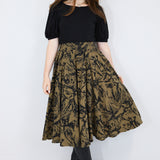 Model wearing a brown twirl circle skirt in a fox print