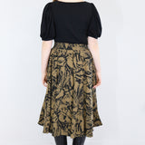 Model wearing a brown twirl circle skirt in a fox print facing backwards