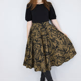 Model wearing a brown twirl circle skirt in a fox print