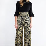 Model wearing mushroom print wide leg pants facing forward 